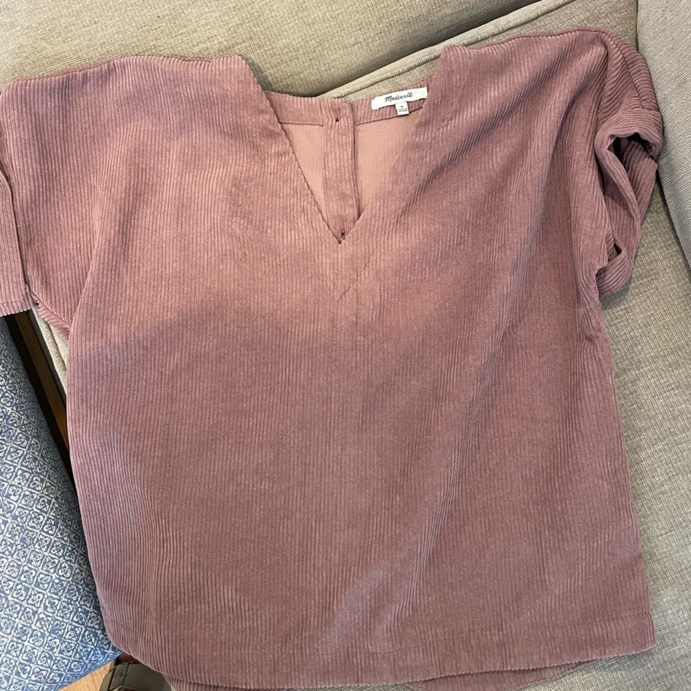Mauve colored corduroy short sleeved shirt with buttons down the back